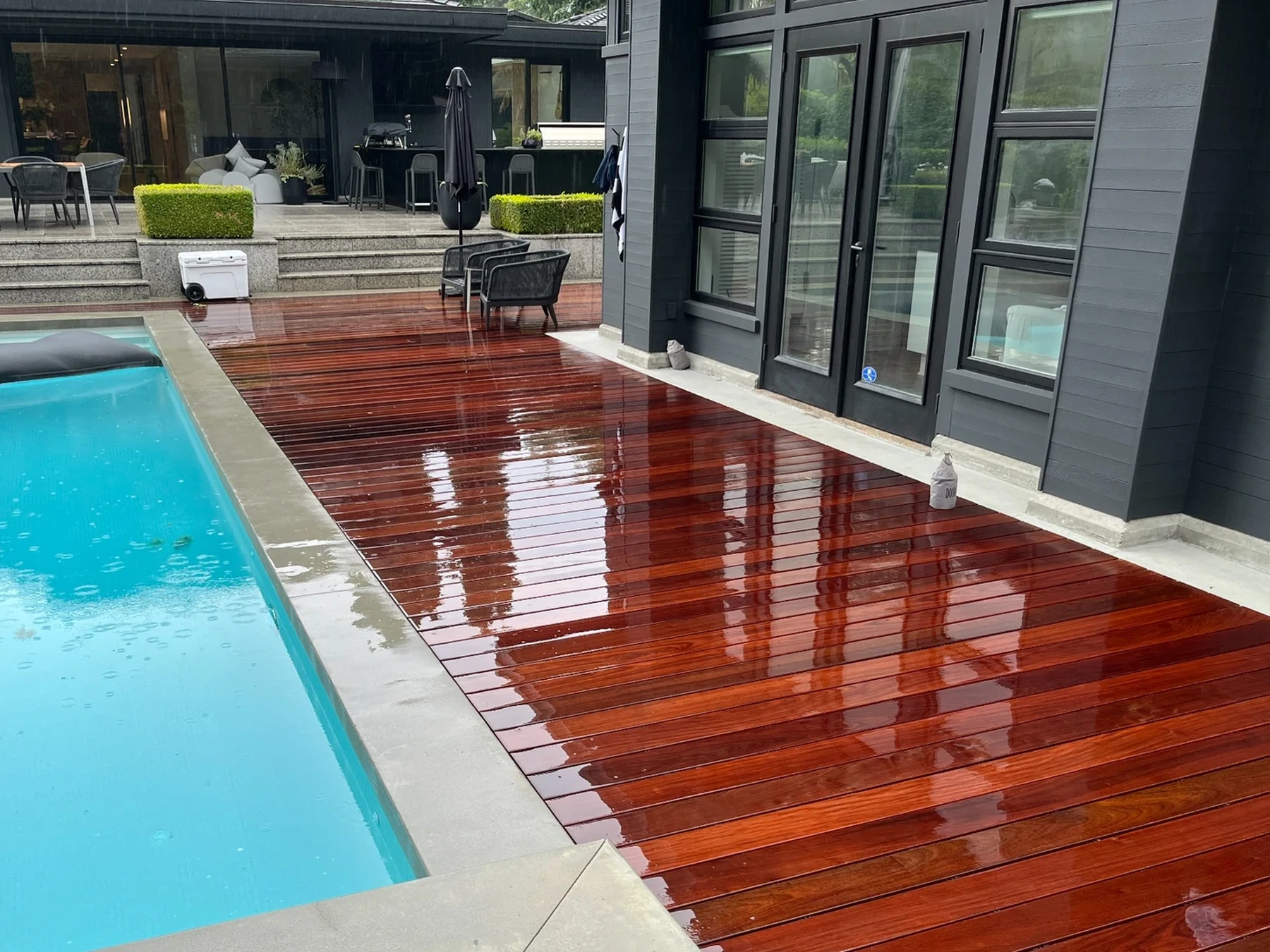 Custom wood decking surrounding a modern pool and spa