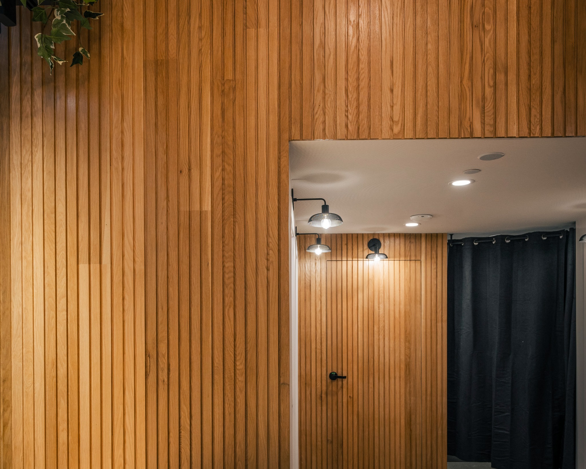 Natural wood Tambour panels wrapping a curved feature wall